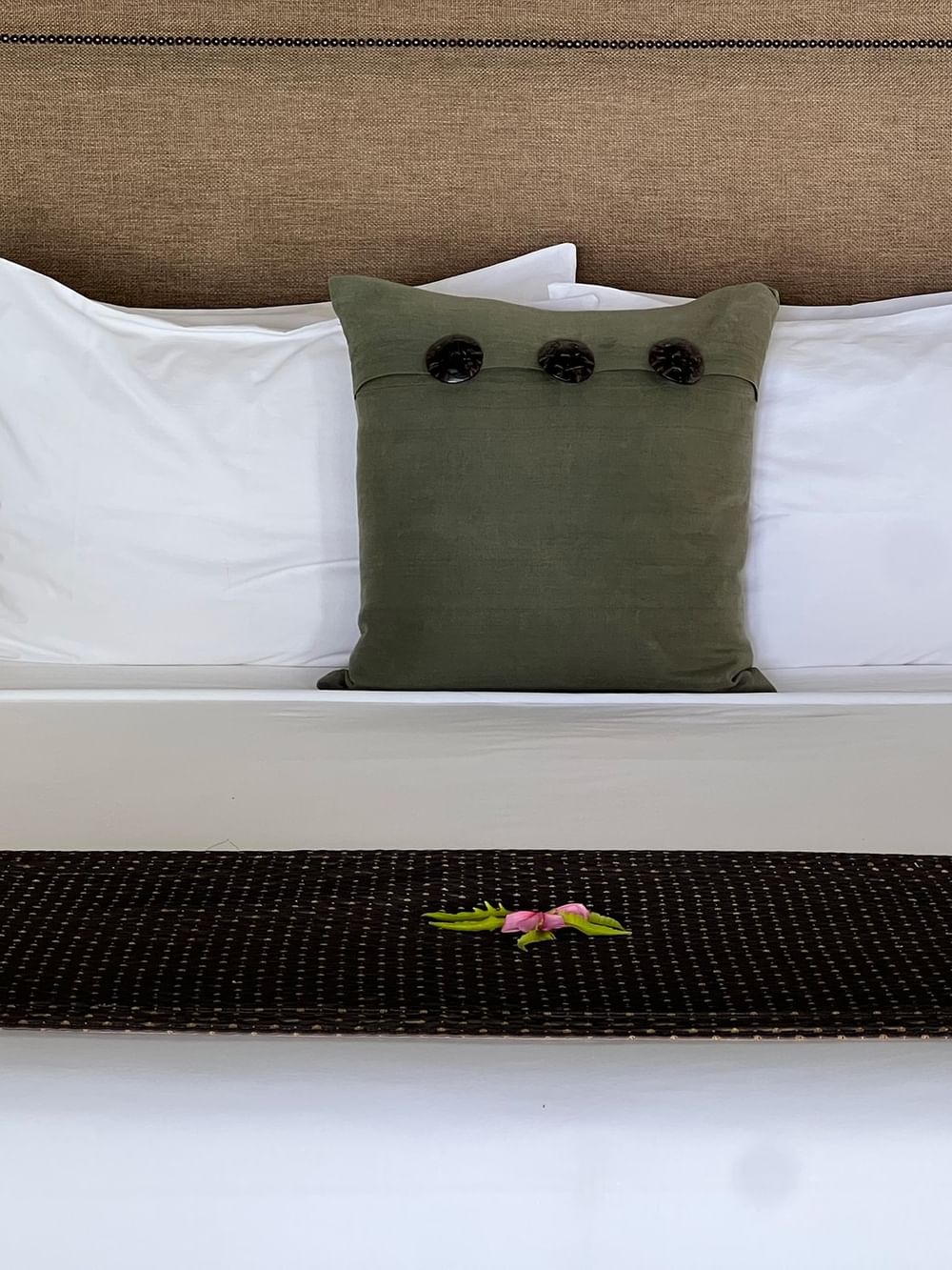 Bed with white linens and green pillow in Shefa Pool Villa at Warwick Le Lagon Vanuatu Efate.