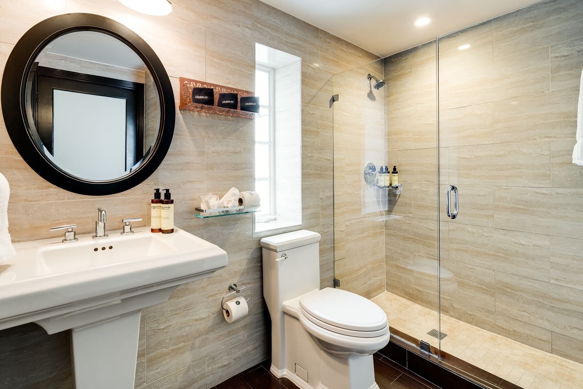 A clean bathroom with a sink, toilet, and shower