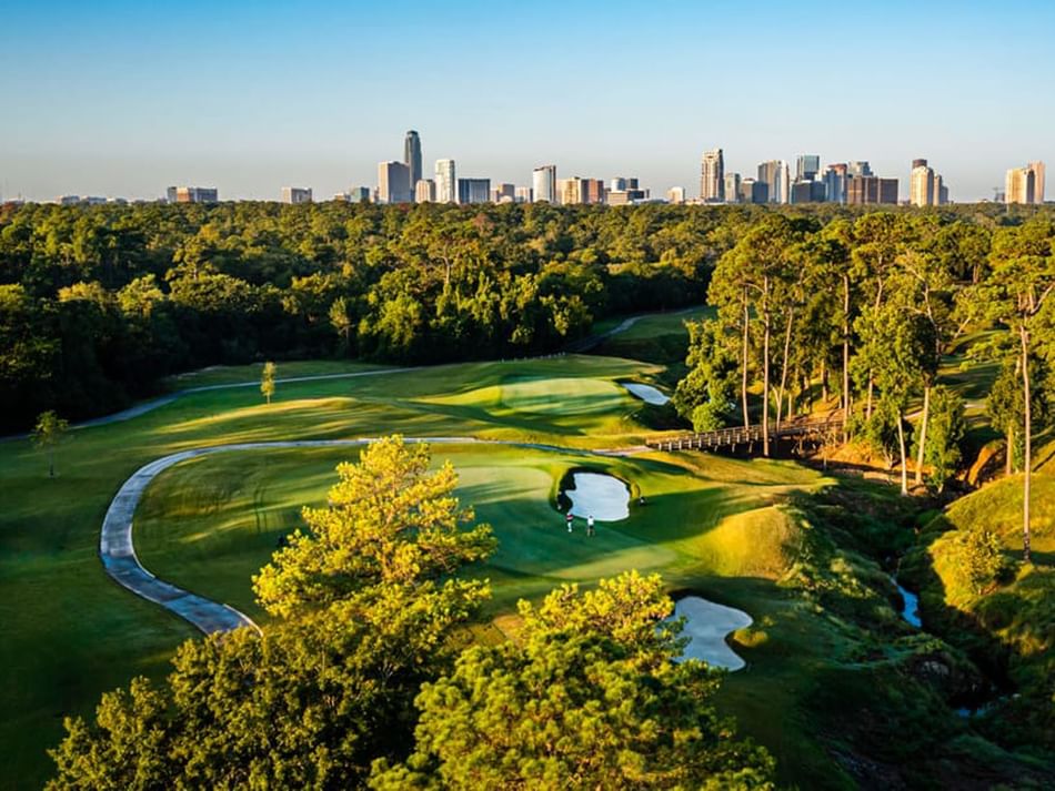 Memorial Park golf course near Granduca Houston, featuring lush greens and the city skyline under a clear morning sky