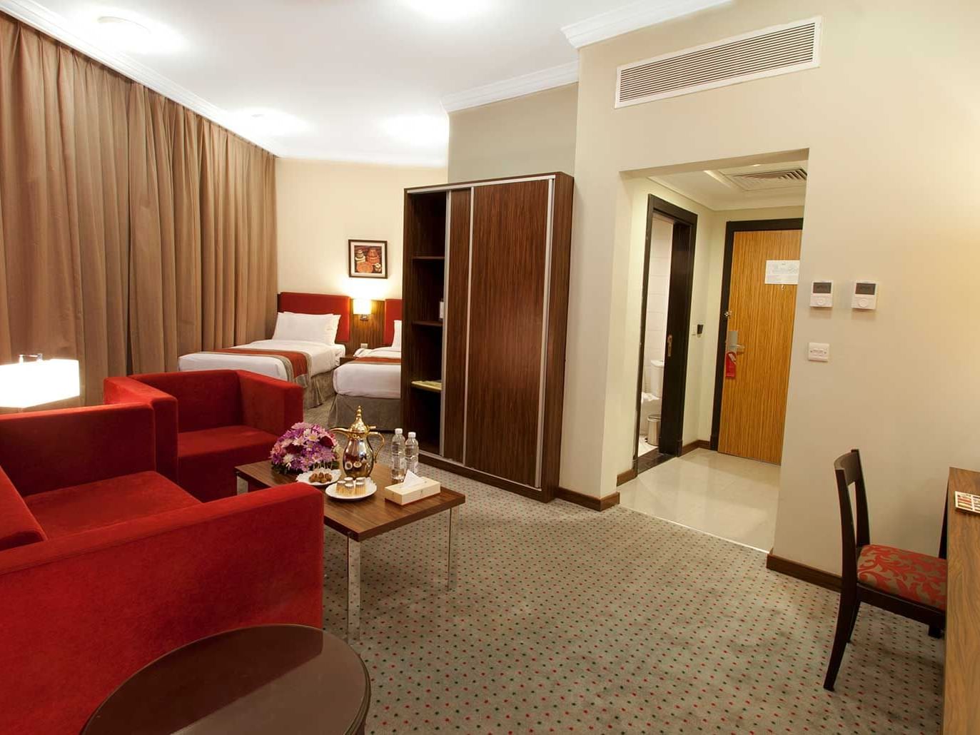 Two beds & lounge area in Twin Room at Elaf Bakkah Hotel