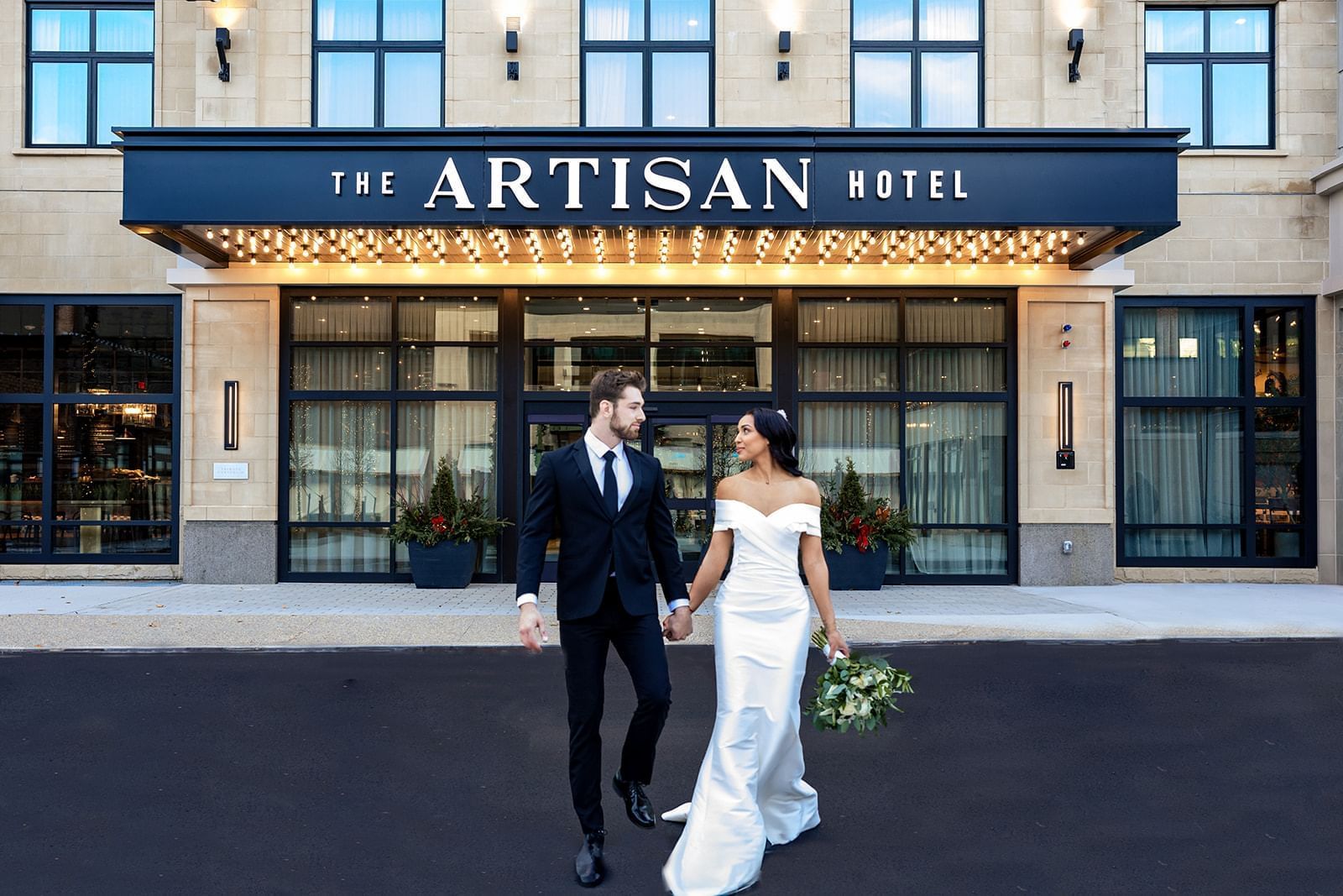 A Wedding couple at the entrance of the Artisan Hotel
