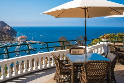 Balcony with wicker chairs and ocean view in Catalina Island suites at Mt Ada