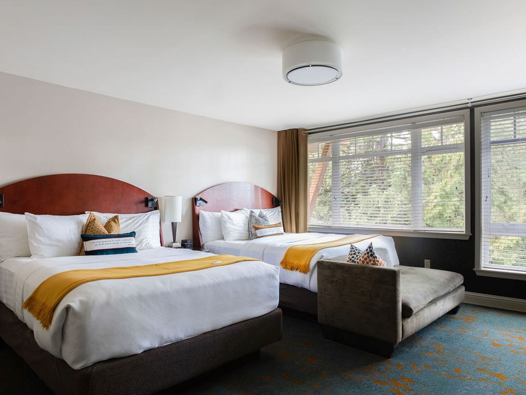 Two beds by the window overlooking the forest in Creekside Double Queen at Alderbrook Resort & Spa