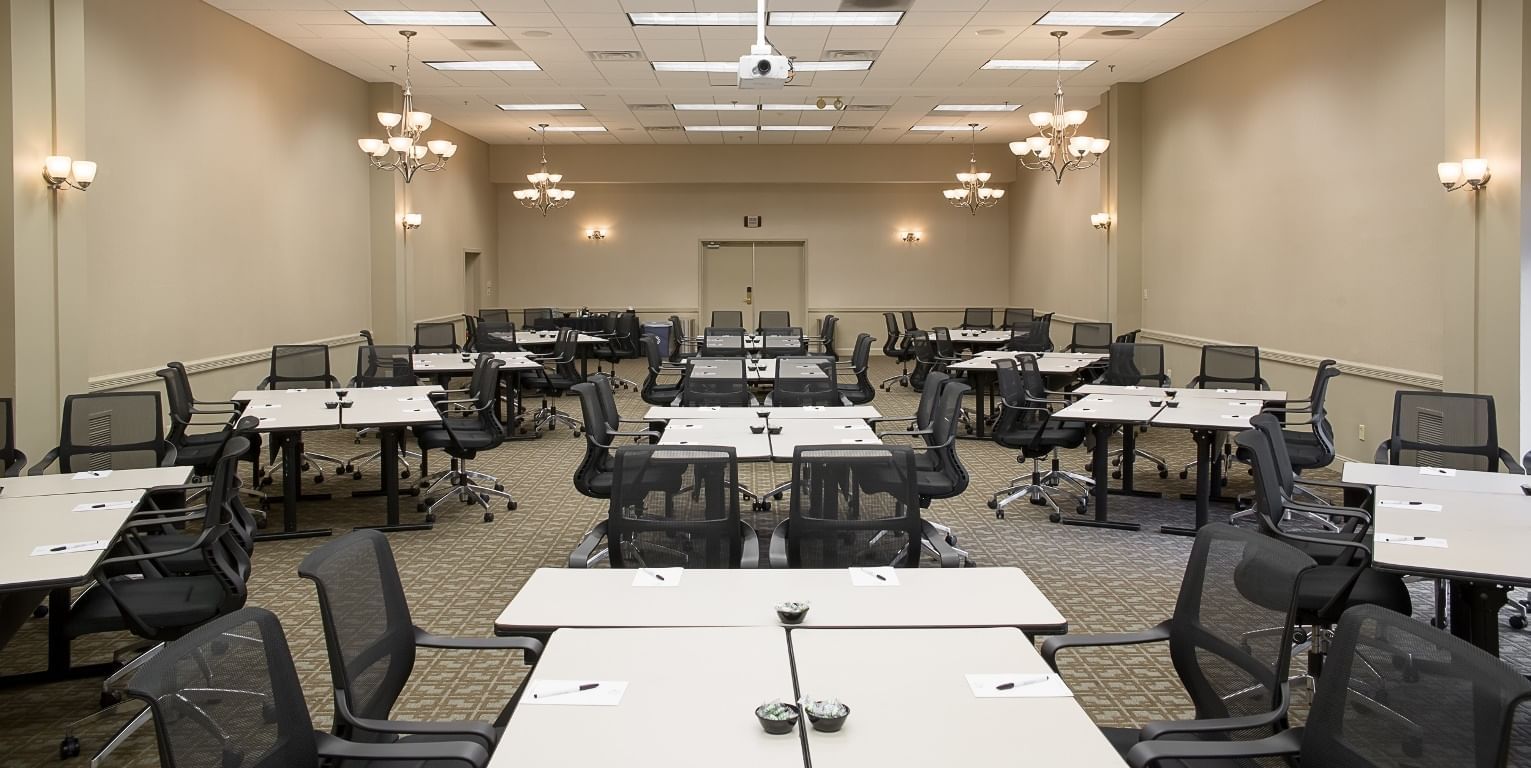 Meeting room with multiple tables and office chairs