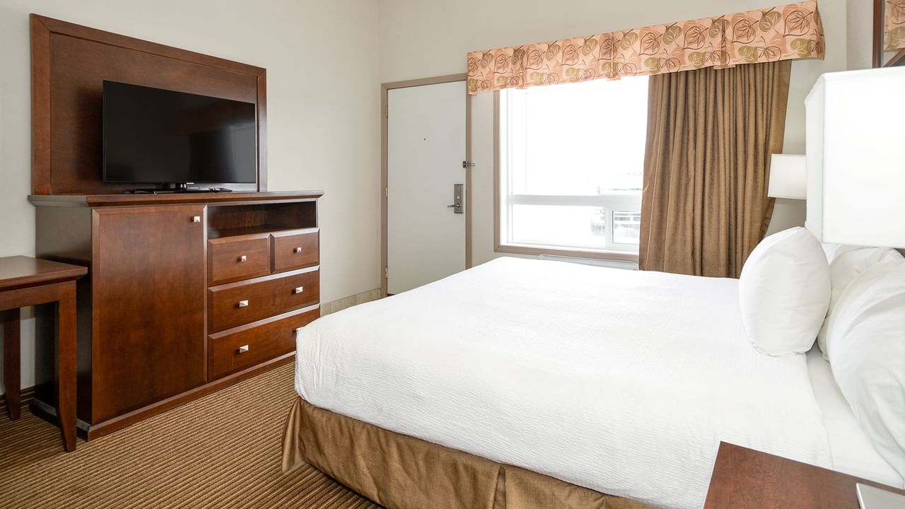 Accessible hotel room with king bed and a large TV