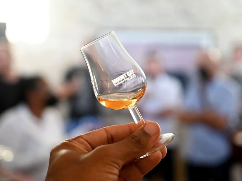 Hand holding a whisky tasting glass at Southern Palms Beach