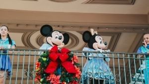 Mickey and Minnie on a balcony at Magic Kingdom greeting guests during their Very Merry Christmas Party.