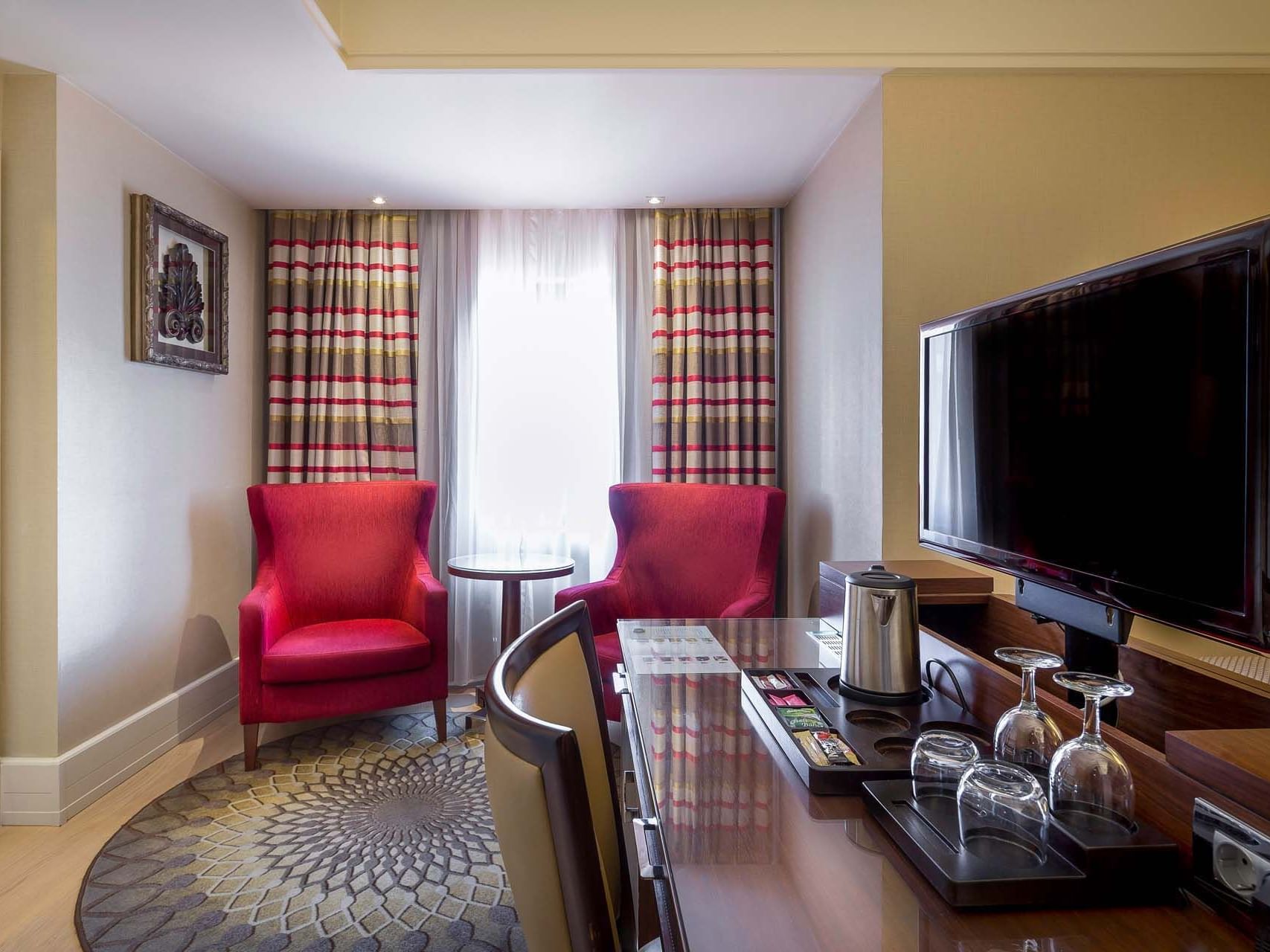 Dining and sitting area with TV in a room at Titanic Comfort Sisli