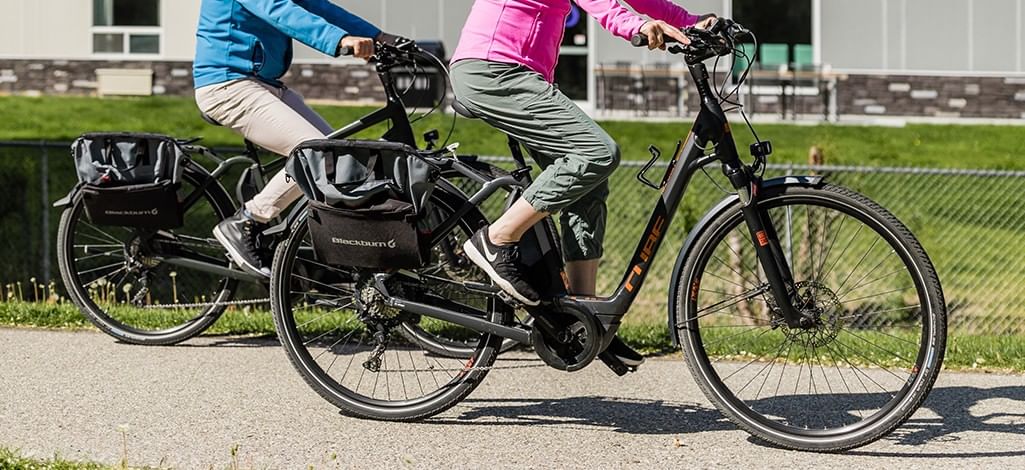 Two people cycling lower half visible