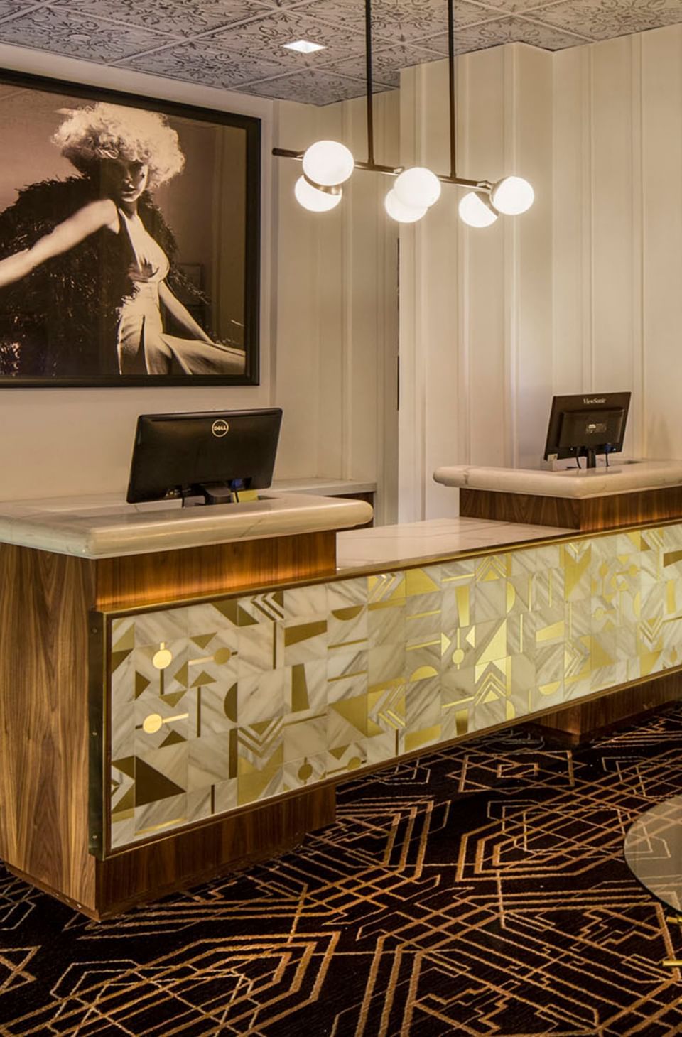 Lobby area with a reception desk and carpeted floors at Hotel Bijou, one of the best boutique hotels in San Francisco
