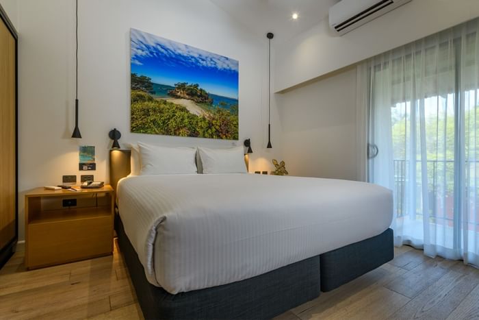 Cozy bed arranged with the bedside cupboard at Novotel Darwin Airport