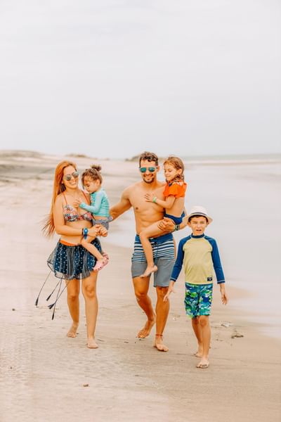 Family walking on the beach near Playa Blanca Resort