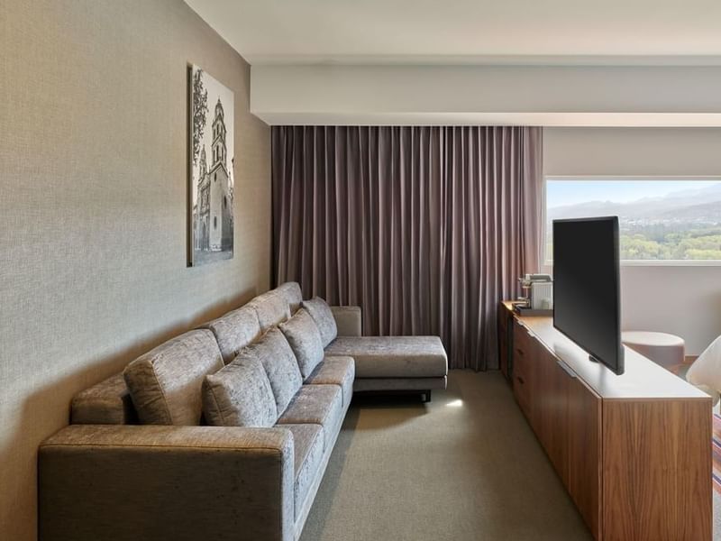 Junior Suite, 2 Double beds, sofa facing TV on wooden cabinet, and large window at Fiesta Americana San Luis Potosí