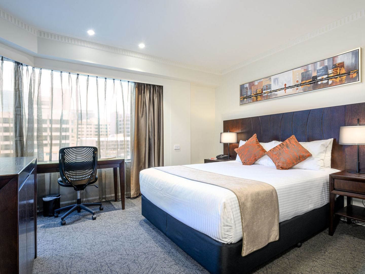 Bed & desk in Executive Queen Room at Hotel Grand Chancellor Adelaide