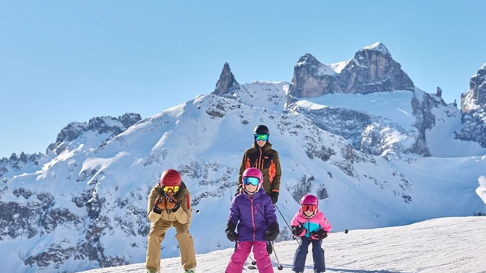 Four skiers on a snowy mountain slope near Falkensteiner Hotel Montafon