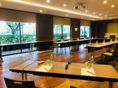 Bright Aquamarin meeting room at The Saujana Hotel Kuala Lumpur with long tables and views of greenery through large windows