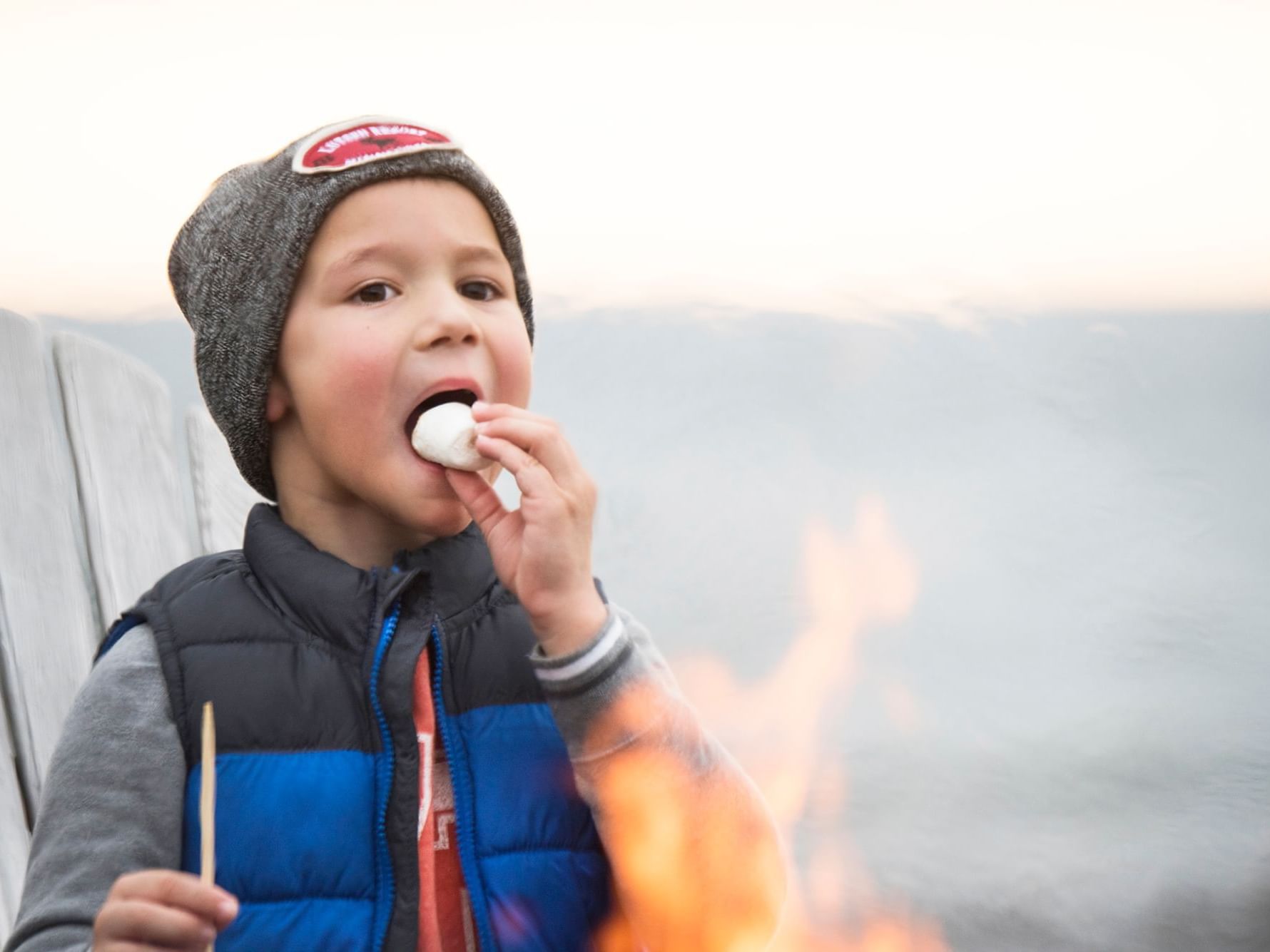A kid eating a marsh mellow at Lutsen Resort