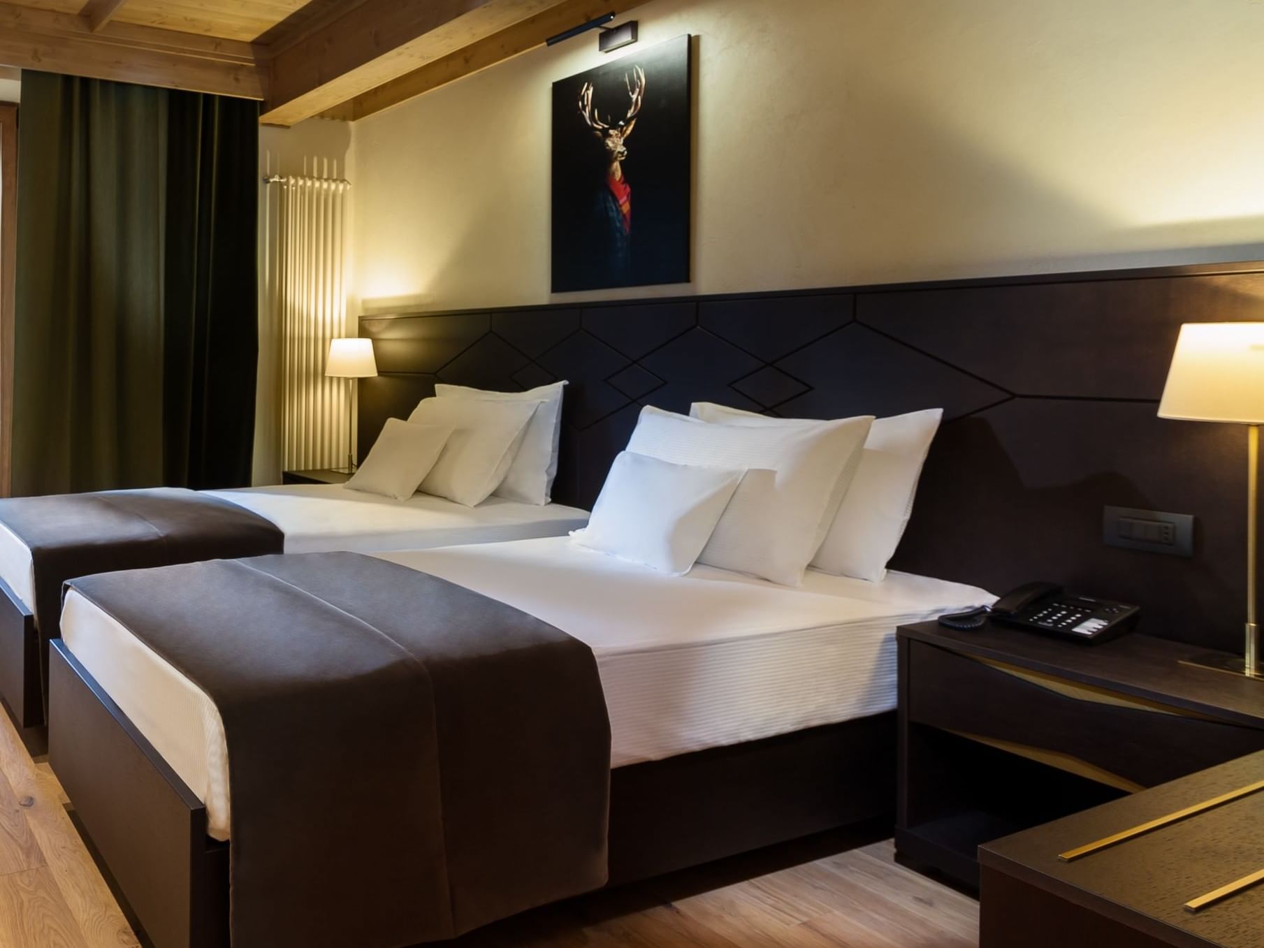 Twin room with two beds, nightstands and a wall art at Ana Hotels Bradul Poiana Brașov