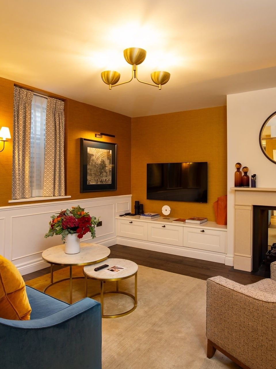 Hyde Park Suite TV lounge with plush sofas near the fireplace at The Capital Hotel, Apartments and Townhouse