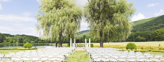 Outdoor wedding ceremony by the lake at Honor’s Haven