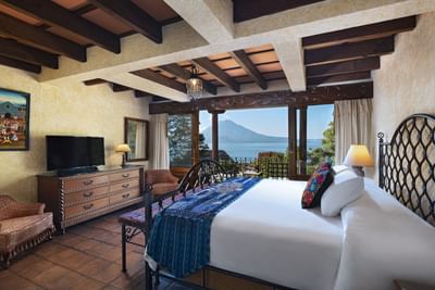 Bed with TV lounge area in One Bed Garden View at Hotel Atitlan