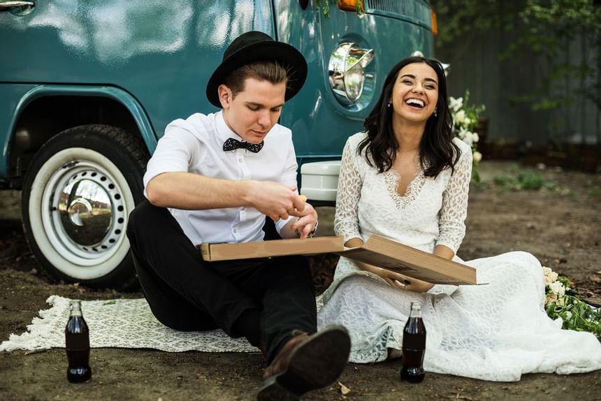a bride and groom having a picnic