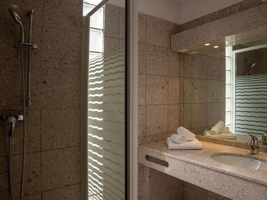 Bathroom vanity in bedrooms at Hotel Les Trois Roses