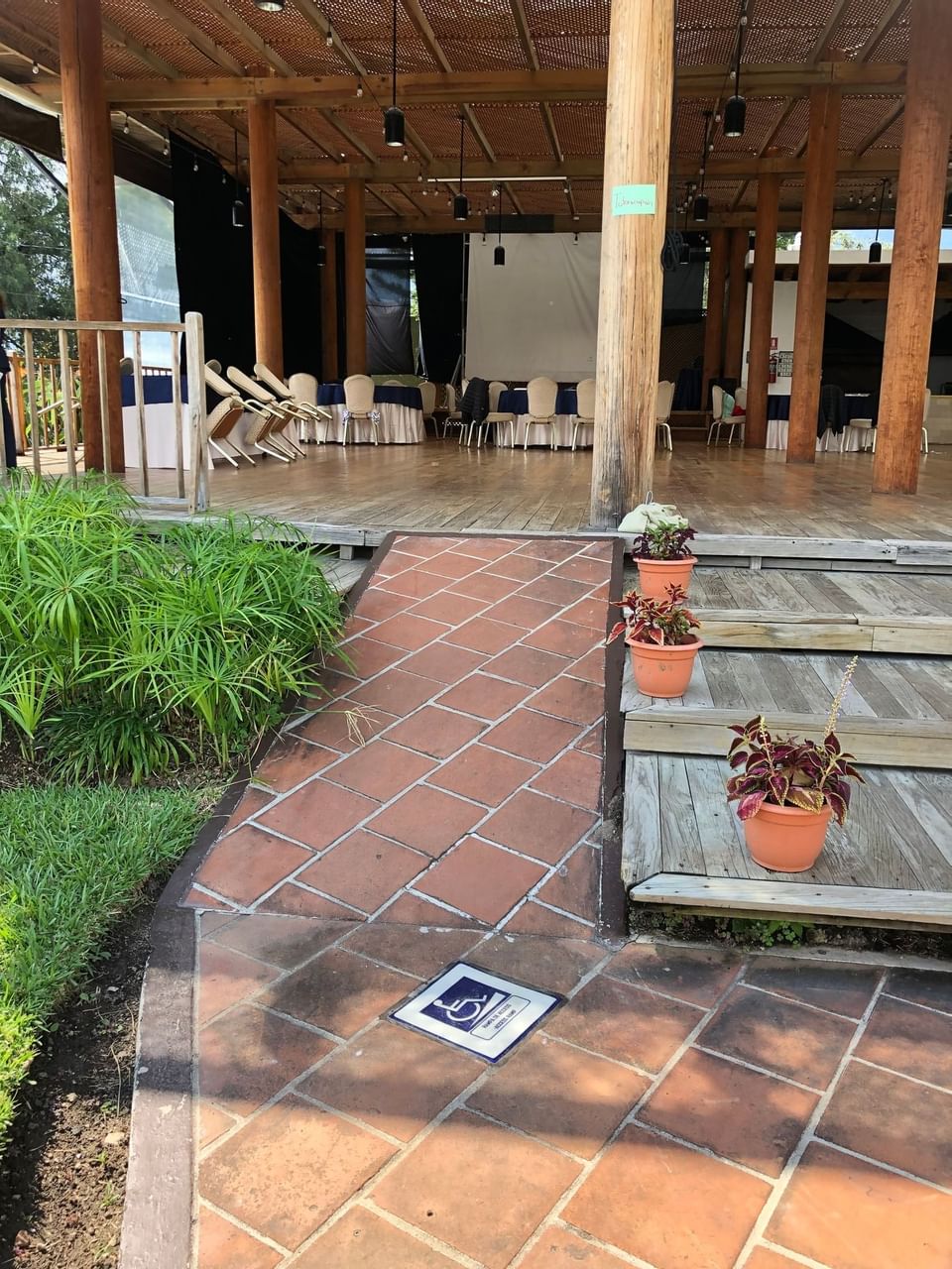 Entrance to an event space with tables & a screen at Porta Hotel del Lago