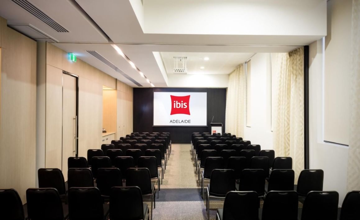 Theater-style set up facing a large screen in The Think Tank at Ibis Adelaide