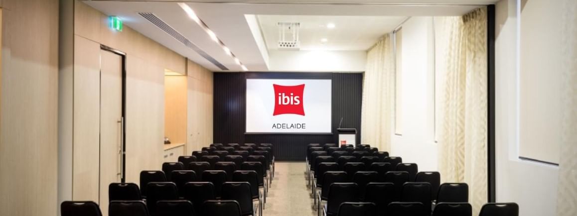 Theater-style setup facing a large screen in The Think Tank at Ibis Adelaide