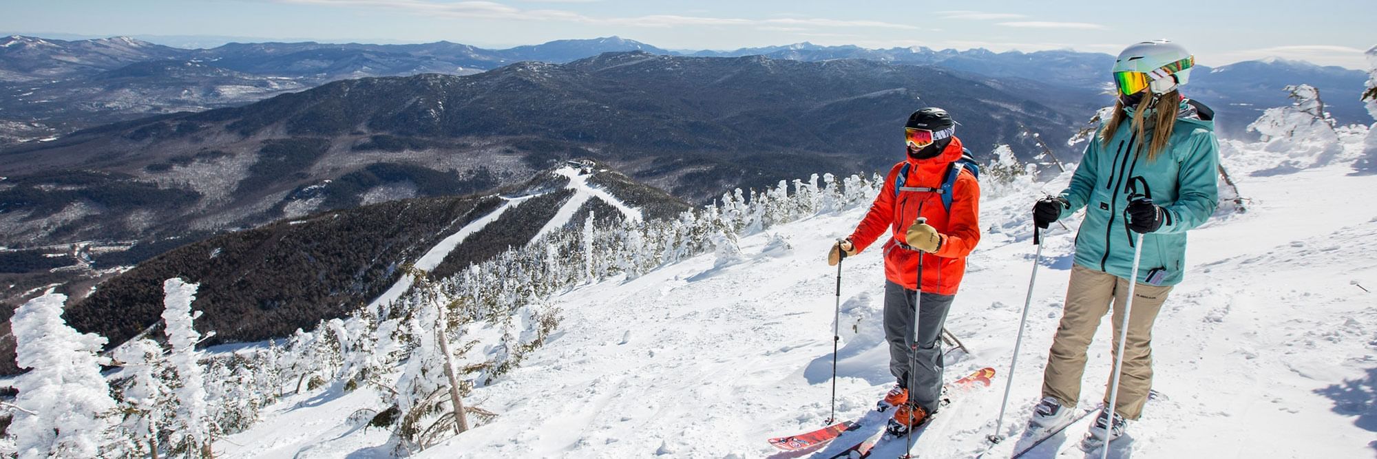 Man and woman on skis overlooking Whiteface Mountain.