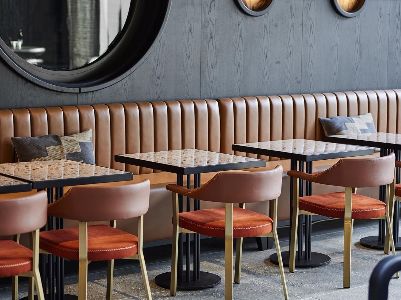 Banquette seating and square tables in Winter Garden at Titanic Comfort Kurfürstendamm