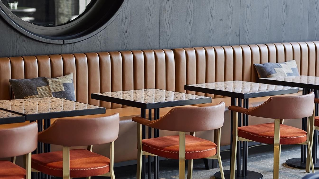 Banquette seating and Square tables in Winter Garden at Titanic Comfort Kurfürstendamm