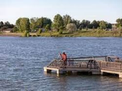 Two men standing on a jetty at Lake Elmo State Park near Boothill Inn & Suites