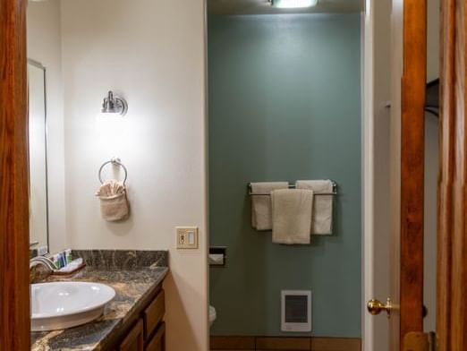 Bathroom vanity with a oval sink and granite countertops in The Hunting Lodge at The Ranch at UCross