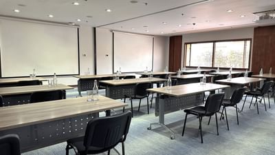 Modern event venues in Bogota with desks and chairs arranged for a conference in a meeting room at Habitel Hotel Select
