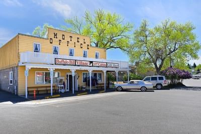 Buffalo Bill Village office and gift shop building with vintage cars parked outside
