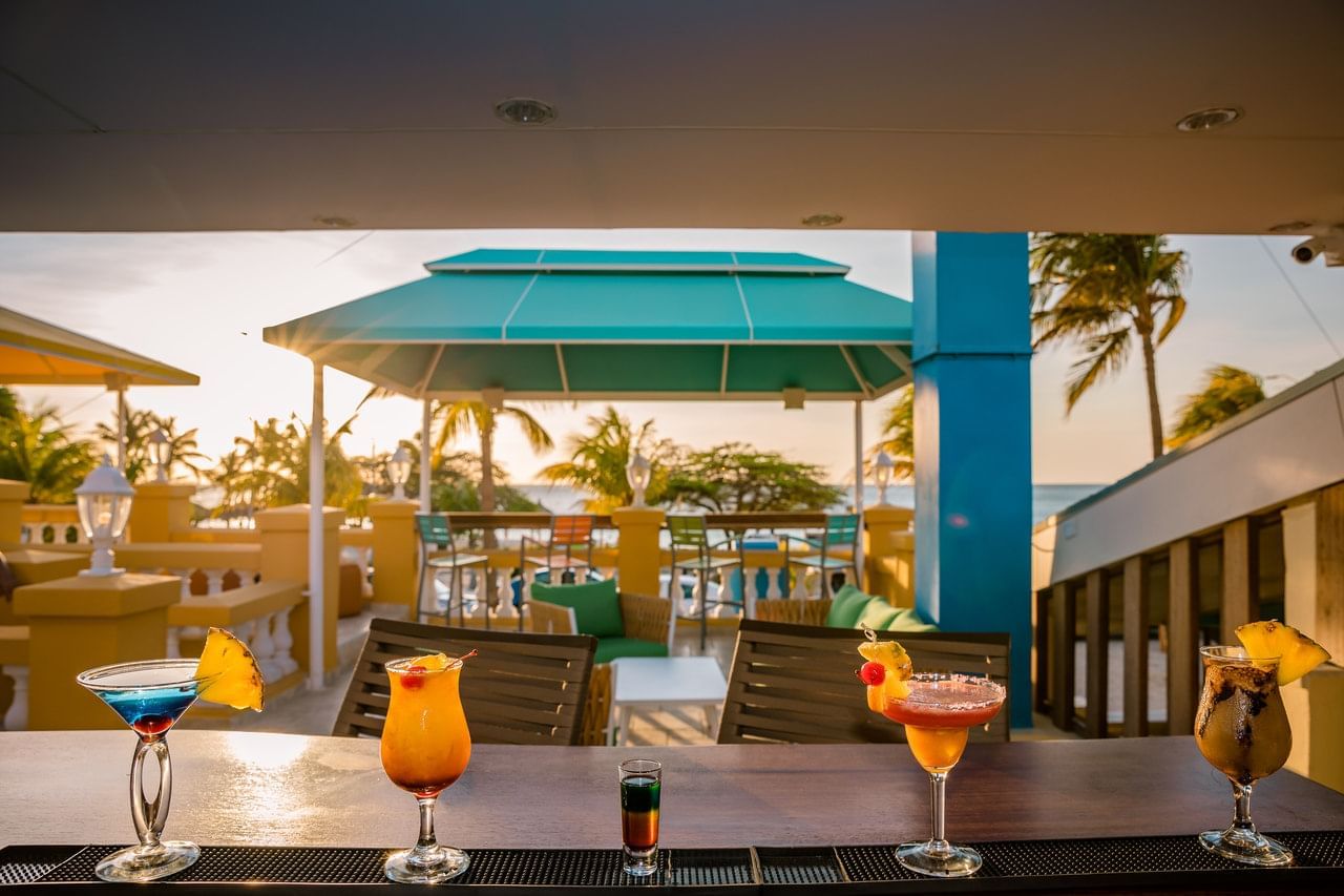 Outdoor bar with variety of drinks served at Amsterdam Manor Beach Resort Aruba