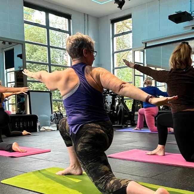 Yoga class at East Park Gym featuring our article on the power of group fitness classes