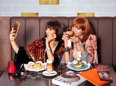 Two girls Taking a selfi with drinks at Tamani Marina Hotel