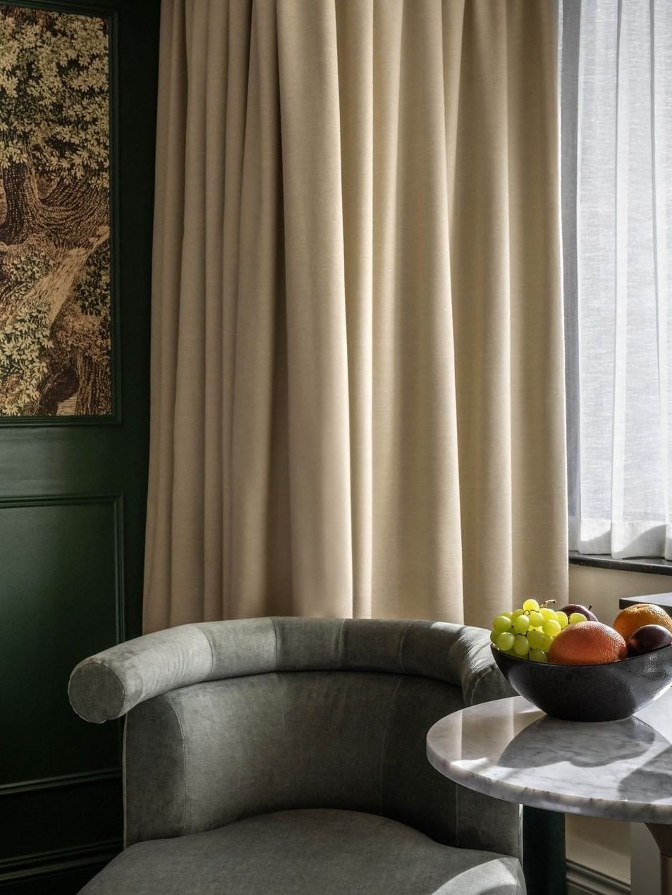 A modern seating area with a table and fruit bowl at The Capital Hotel, Apartments & Townhouse in London