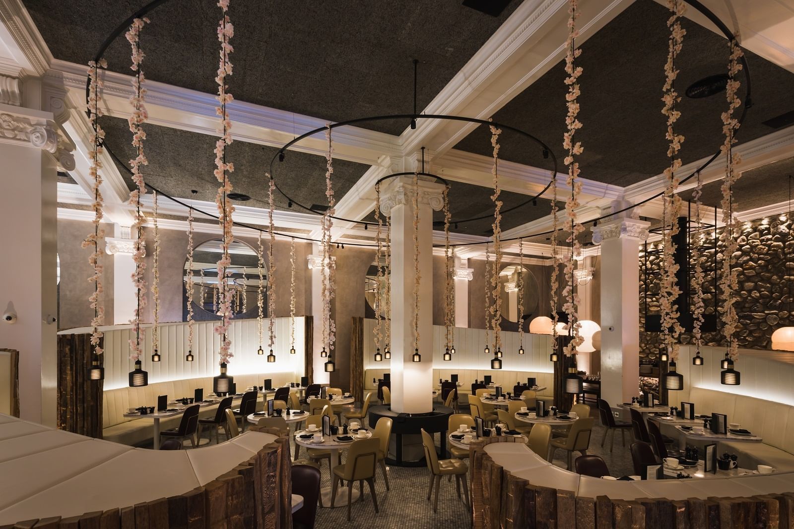 Dining tables, lighting & decorative hanging floral strings from the ceiling at Peter Street Kitchen