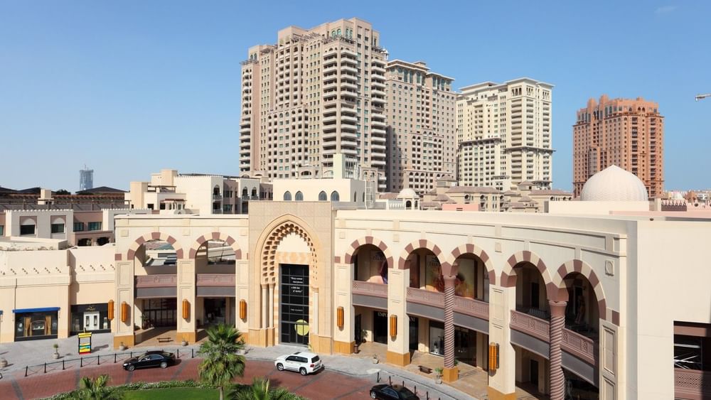 Modern architectural complex with tall buildings and a shopping center in Doha.