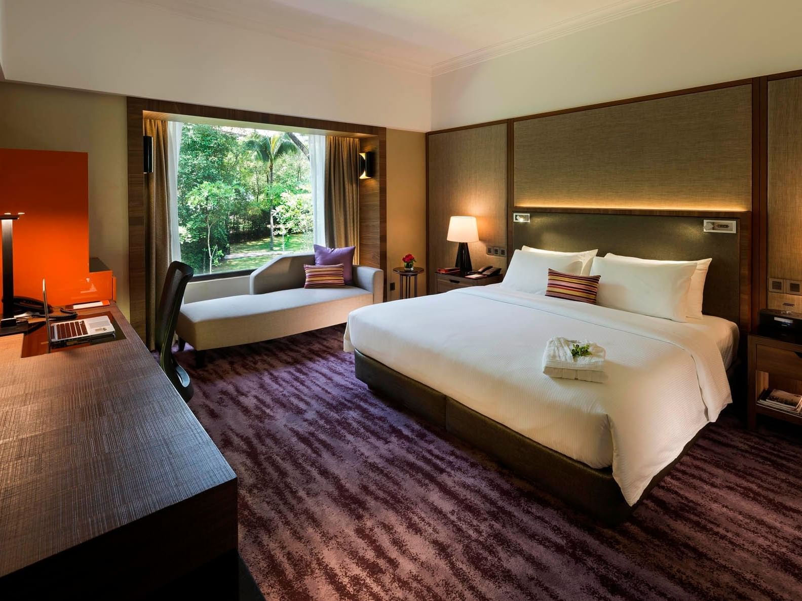 Executive Deluxe Room at The Saujana Hotel Kuala Lumpur with a king bed, desk, seating by a window overlooking greenery