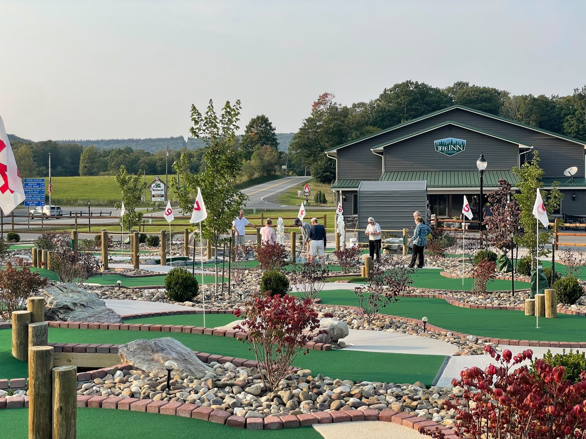 Group of elderly visitors enjoying playing golf in the 8-Hole Mini Golf Course at The Inn at Canaan