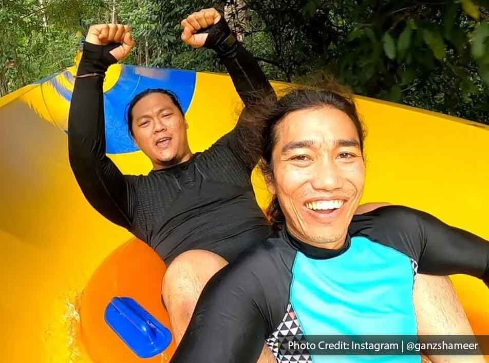 Two men enjoy the water sliding activity at Penang Escape Adventure Theme Park - Lexis Suites Penang