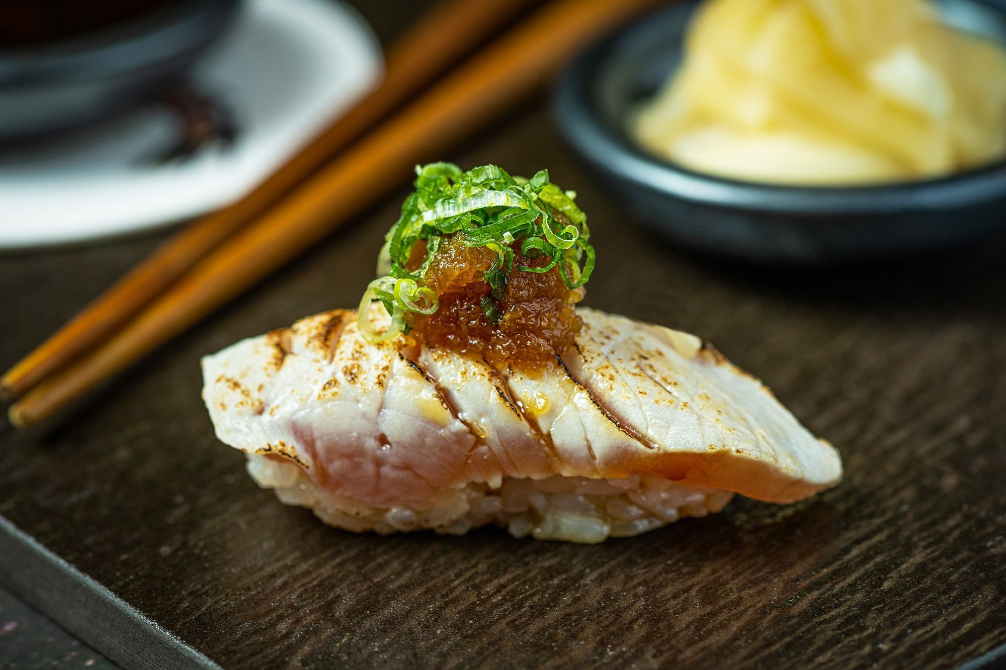a piece of sushi on a wooden plate