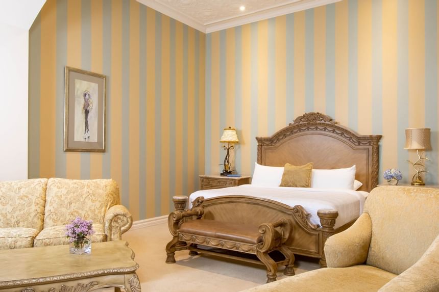 a large king size bed is the focus in the middle of a large room