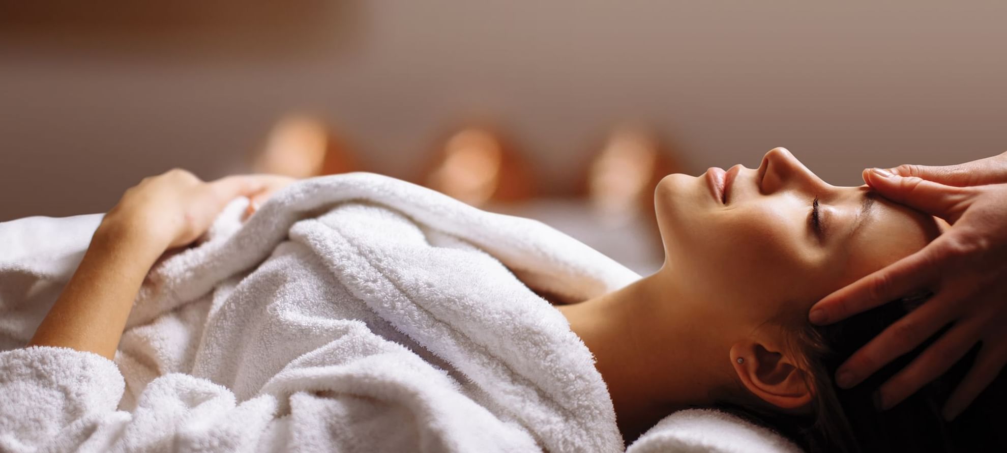 Lady receiving a head massage in Fullerton Spa at The Fullerton Bay Hotel Singapore