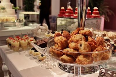 A lavish dessert table at Hotel Mykonos with platters of cookies, cupcakes, and other sweet treats